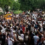 India activists demand release of detained 'cockroach' protesters